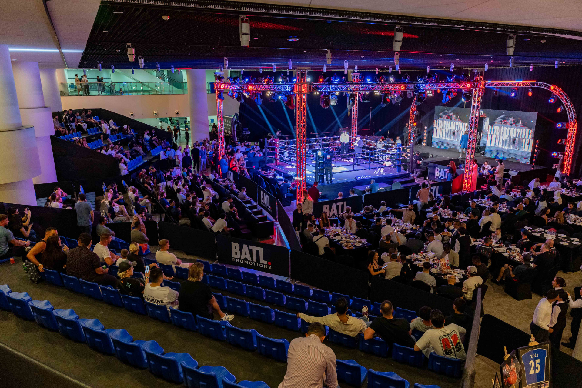 BATL boxing arena filled with spectators around a lit ring